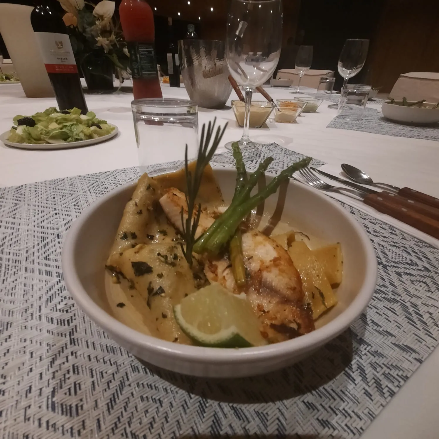 A plated kosher main of seared fish over fresh pappardelle with herbs and lime at a Riviera Maya villa dinner