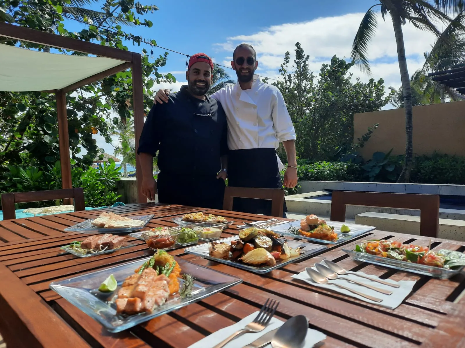 Chef Orel and his private kosher kitchen team behind a fully plated table at a Riviera Maya villa
